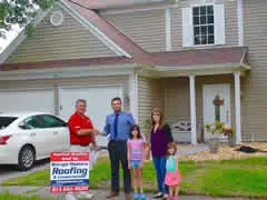 Family in front of home with Shingle Master Crew Member